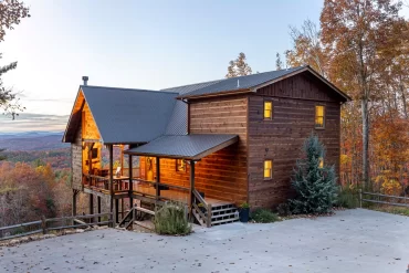 A side view of a Stay and Play cabin before sunset.